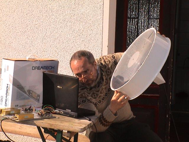 Me holding an antenna and looking at the computer screen